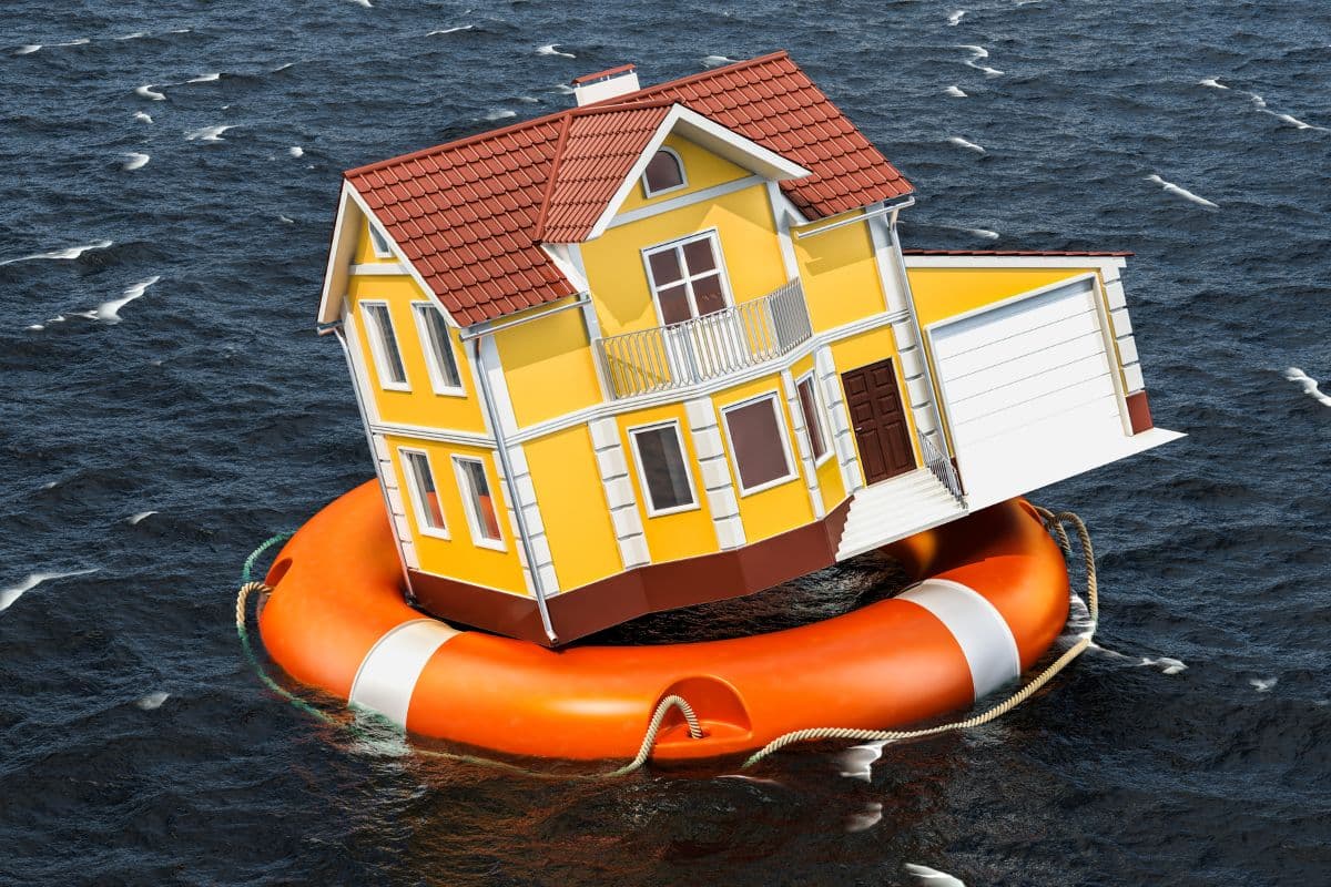 Homeowner reviewing basement waterproofing finances and insurance documents