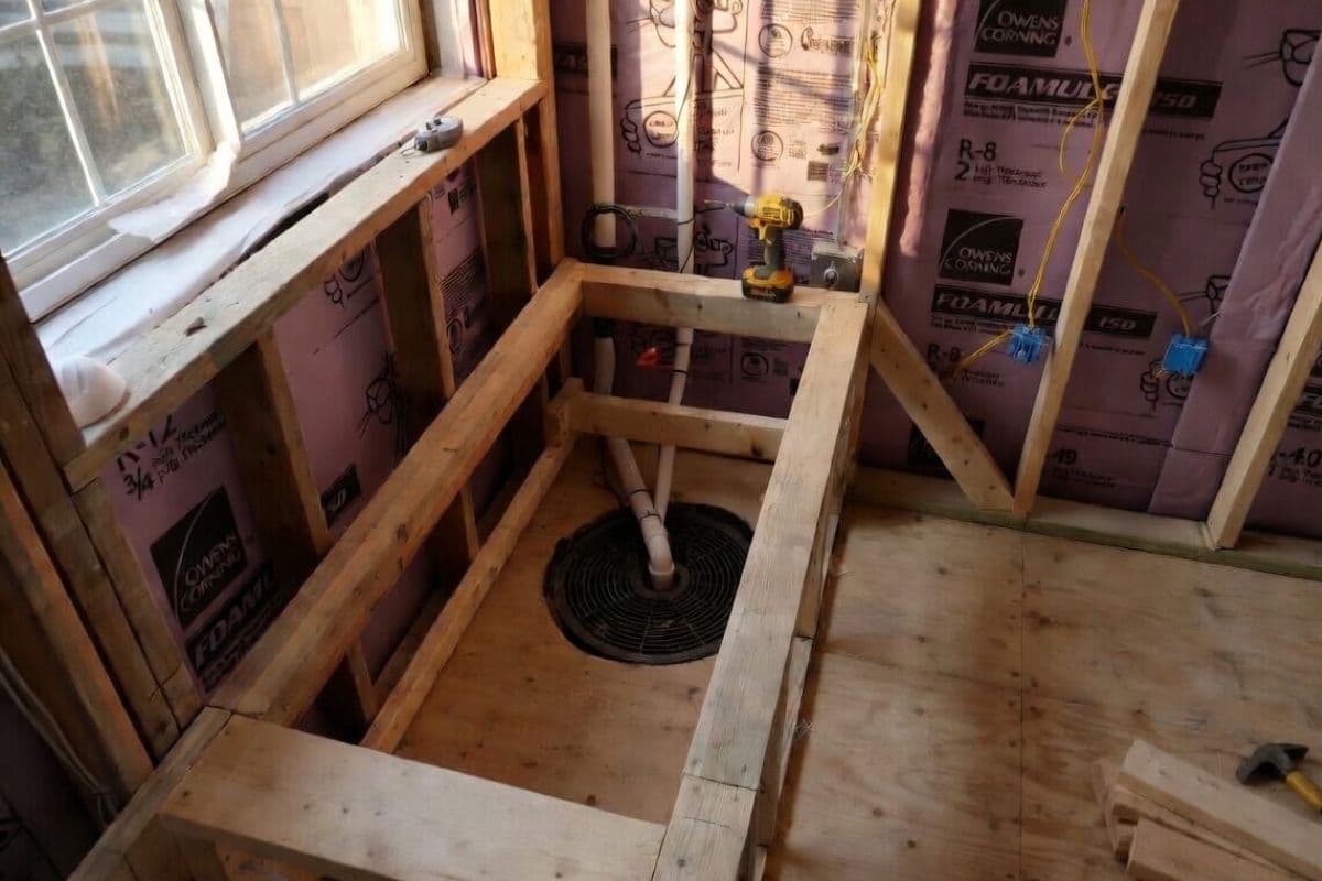 Finished basement with sump pump enclosed in built-in cabinetry